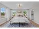 Spacious primary bedroom boasts carpet, lots of windows, ceiling fan, and stylish decor at 910 Kensley Grove Ln # 70, Fuquay Varina, NC 27526