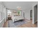 Spacious primary bedroom boasts carpet, lots of windows, ceiling fan, and stylish decor at 910 Kensley Grove Ln # 70, Fuquay Varina, NC 27526