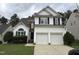 Charming two-story home with a two car garage, complemented by a well-maintained lawn and garden at 10 Gwendolyn Cir, Durham, NC 27703