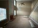 Living room with tall ceilings, fireplace, and multiple windows at 10 Gwendolyn Cir, Durham, NC 27703