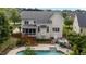 Aerial view of a spacious backyard with a pool, deck, and screened-in porch at 1004 Taywood Way, Apex, NC 27502