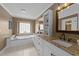 Bathroom featuring a tub, vanity with granite countertops, and double sinks at 1004 Taywood Way, Apex, NC 27502