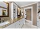 Elegant bathroom featuring double sinks, granite countertops, and a separate toilet room at 1004 Taywood Way, Apex, NC 27502