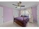 Comfortable bedroom with a queen-size bed, soft carpet, and a large window with natural light at 1004 Taywood Way, Apex, NC 27502