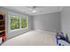Serene bedroom with a large window providing ample natural light and a view of the outdoors at 1004 Taywood Way, Apex, NC 27502