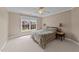 Neutral bedroom with a queen-size bed, two side tables, and a view of the outside at 1004 Taywood Way, Apex, NC 27502