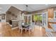 Bright dining area with a neutral color palette, wood flooring, and a walkout to an outdoor patio at 1004 Taywood Way, Apex, NC 27502