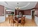 Formal dining room featuring hardwood floors, a chandelier, and a table set for elegant dining at 1004 Taywood Way, Apex, NC 27502