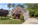 Well-maintained brick home featuring a pristine lawn and professional landscaping at 1004 Taywood Way, Apex, NC 27502