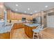 Spacious kitchen featuring stainless steel appliances, granite countertops, wood cabinets, and a center island at 1004 Taywood Way, Apex, NC 27502