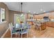 Eat-in kitchen with granite counters, stainless appliances, wood cabinets, a dining table and a breakfast bar at 1004 Taywood Way, Apex, NC 27502