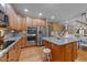Spacious kitchen featuring stainless steel appliances, granite countertops, wood cabinets, and a center island at 1004 Taywood Way, Apex, NC 27502