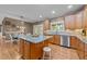 Inviting kitchen with stainless steel appliances, granite countertops, wood cabinets, and a center island at 1004 Taywood Way, Apex, NC 27502
