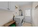 Functional laundry room equipped with modern washer and dryer, storage, and access door at 1004 Taywood Way, Apex, NC 27502