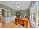 Bright office with a large wood desk, hutch, and large windows providing abundant natural light at 1004 Taywood Way, Apex, NC 27502