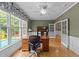 This office features a hardwood floor, built-in shelving, large windows, and a modern chair at 1004 Taywood Way, Apex, NC 27502