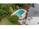 Aerial view of in-ground pool and deck featuring lounge seating and lush landscaping at 1004 Taywood Way, Apex, NC 27502