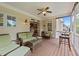 Comfortable screened porch with wood flooring, wicker furniture, ceiling fan, and outdoor access at 1004 Taywood Way, Apex, NC 27502