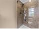Modern shower with a glass door, tiled walls, and a built-in shelf for toiletries at 1004 Taywood Way, Apex, NC 27502
