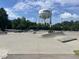 Outdoor skate park featuring concrete ramps, rails, and an Apex water tower in the background at 1004 Taywood Way, Apex, NC 27502