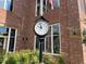 Street view featuring the Town of Apex clock in front of a brick building with an American Flag at 1004 Taywood Way, Apex, NC 27502