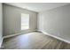 Neutral bedroom featuring vinyl floors, a window, and a closet door at 1039 Bellenden Dr, Durham, NC 27713