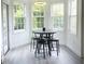 Bright breakfast nook with a round table, four chairs, and three large windows offering natural light at 1039 Bellenden Dr, Durham, NC 27713