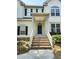 Inviting front entrance featuring brick steps, a covered porch, and a classic black front door at 1039 Bellenden Dr, Durham, NC 27713