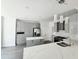 Modern kitchen with sleek gray cabinets, stainless steel appliances, and a large island with a quartz countertop at 1039 Bellenden Dr, Durham, NC 27713