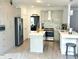 Modern kitchen with stainless steel appliances, light gray cabinets, and quartz countertops at 1039 Bellenden Dr, Durham, NC 27713