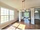 Spacious living room with hardwood floors, large windows, and decorative columns at 1039 Bellenden Dr, Durham, NC 27713