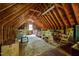 A large and cluttered attic with an exposed frame. An open window allows natural light at 108 Farren Ct, Cary, NC 27511