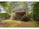 Sprawling backyard featuring a patio, screened-in porch, mature trees, and lush greenery at 108 Farren Ct, Cary, NC 27511