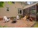 Charming brick patio with white Adirondack chairs and access to the screened porch at 108 Farren Ct, Cary, NC 27511