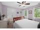 Bedroom features a wood frame bed, soft natural light, and access to an ensuite bathroom at 108 Farren Ct, Cary, NC 27511