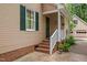 Welcoming front entrance with brick steps, white railings, and a charming hanging flower basket at 108 Farren Ct, Cary, NC 27511