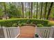 View of the lush front yard from the porch showing garden beds and mature trees at 108 Farren Ct, Cary, NC 27511