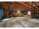 Large garage interior with wood framing, concrete floor, and ample storage space for tools and equipment at 108 Farren Ct, Cary, NC 27511