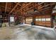 Spacious two-car garage interior featuring an exposed wood frame ceiling and a concrete floor at 108 Farren Ct, Cary, NC 27511