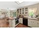 Bright kitchen featuring glass cabinets, wooden countertops, and stainless steel appliances at 108 Farren Ct, Cary, NC 27511