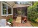 Outdoor patio with brickwork, Adirondack chairs, and access to a screened-in porch at 108 Farren Ct, Cary, NC 27511