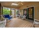 Inviting screened porch featuring a ceiling fan, skylight, and comfortable wicker furniture at 108 Farren Ct, Cary, NC 27511