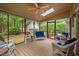 Relaxing screened porch with wicker furniture and backyard view of the detached garage at 108 Farren Ct, Cary, NC 27511