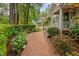 Brick walkway leads to the house through lush gardens, offering a picturesque and inviting approach at 108 Farren Ct, Cary, NC 27511