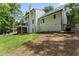 Expansive backyard with lush lawn, deck, screened porch, and meticulous landscaping at 10817 Brass Kettle Rd, Raleigh, NC 27614