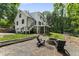 Beautifully landscaped backyard featuring a fire pit and ample seating at 10817 Brass Kettle Rd, Raleigh, NC 27614