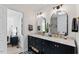 Elegant bathroom featuring a dual vanity with marble countertop and modern fixtures at 10817 Brass Kettle Rd, Raleigh, NC 27614