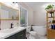 Bathroom with a sleek, white tub, dark fixtures, and modern vanity at 10817 Brass Kettle Rd, Raleigh, NC 27614