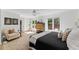 Bright and airy bedroom with large windows, neutral tones, and a cozy seating area at 10817 Brass Kettle Rd, Raleigh, NC 27614