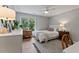 Cozy bedroom boasts hardwood floors, natural light, desk, and a comfortable bed, creating a tranquil retreat at 10817 Brass Kettle Rd, Raleigh, NC 27614